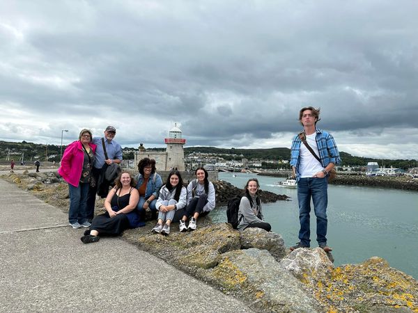 students standing by lake