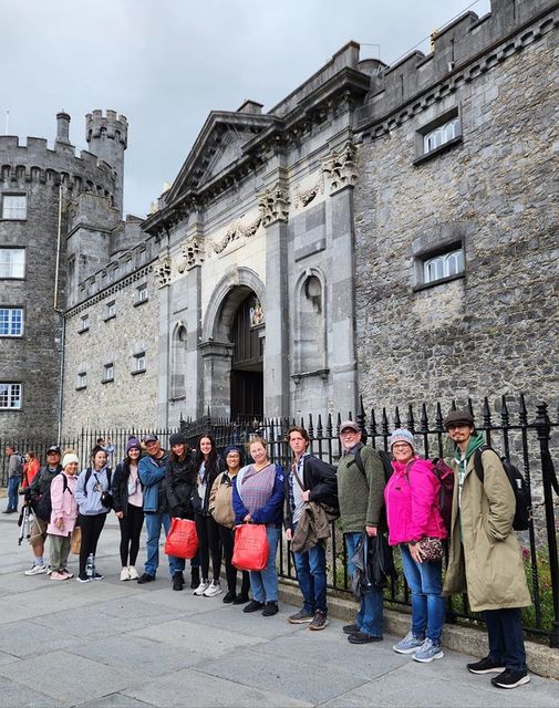 students standing in front of historical building