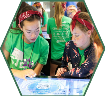 Two campers use the interactive STEM tables at the Oklahoma City National Memorial & Museum  to solve a problem.