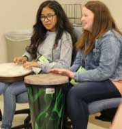 Two SAGE STEAM Campers playing the bongos